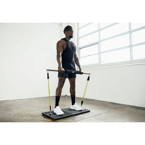 PTP Resistance Platform in use for a squat exercise with resistance tubes