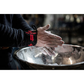 Harbinger chalk worked into hands over a gym chalk bowl